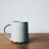 Glazed ceramic coffee mug on wood table