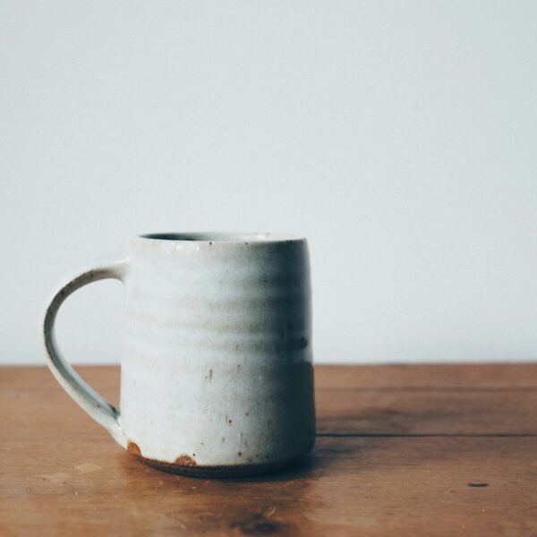 Glazed ceramic coffee mug on wood table